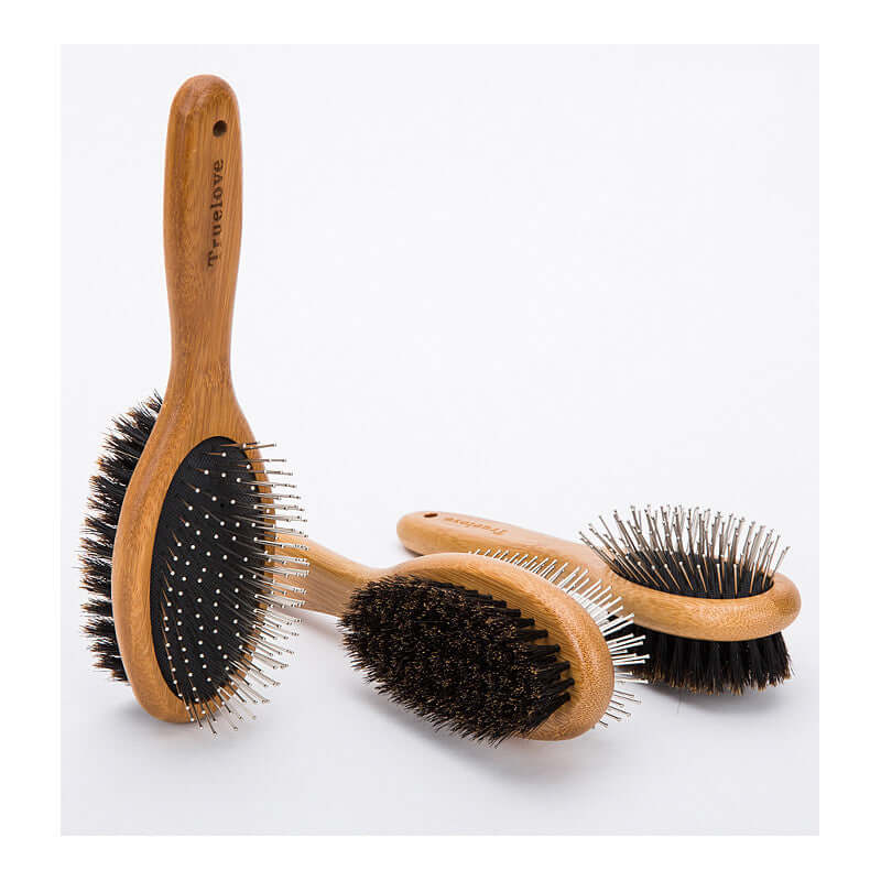 Three wooden-handled double-sided dog cleaning brushes with soft and bristle sides for grooming and massaging coats.