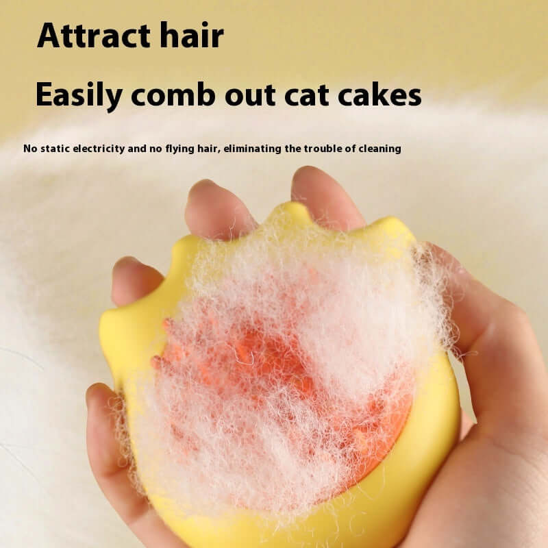 Yellow pet bath brush with cat fur, showing hair attraction properties for easy grooming of cats and dogs.