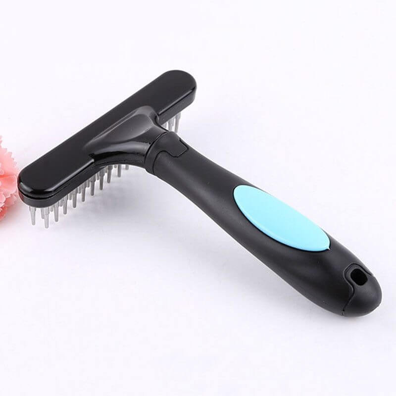 Pet hair removal brush with ergonomic grip and stainless steel bristles for effective grooming and knot removal.