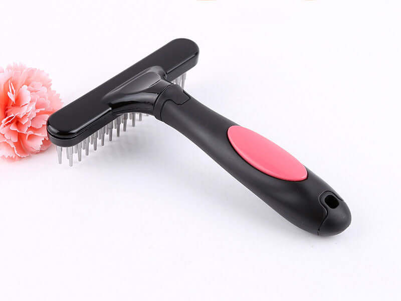 Pet hair removal brush with ergonomic grip and stainless steel bristles on a white background for effective grooming.